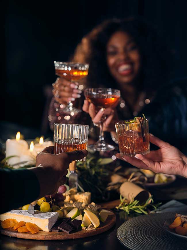 Photo by The OurWhisky Foundation 🥃: https://www.pexels.com/photo/closeup-of-people-making-a-toast-with-whiskey-glasses-over-a-table-with-food-19095108/